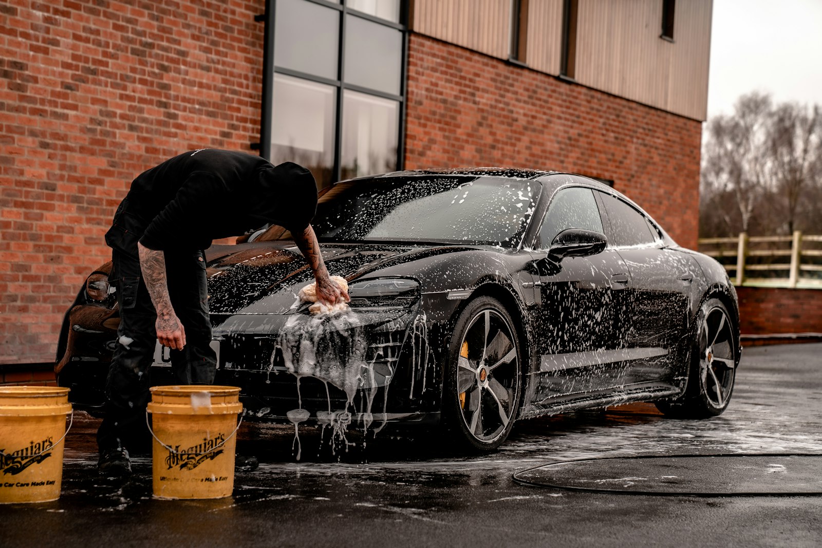 Hand-detailing a car with a microfiber cloth