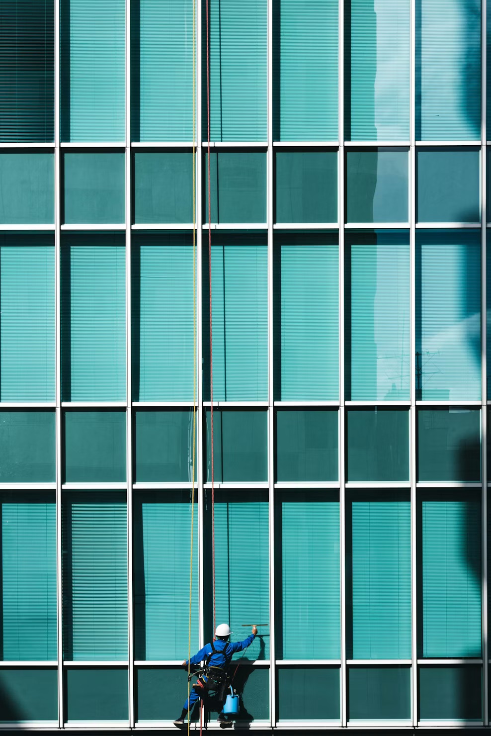 ClearVue technician cleaning a glass building facade